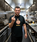 Restaurant cook wearing Eff Brunch Tee - black t-shirt with yellow middle-finger brunch graphic, commercial kitchen lifestyle